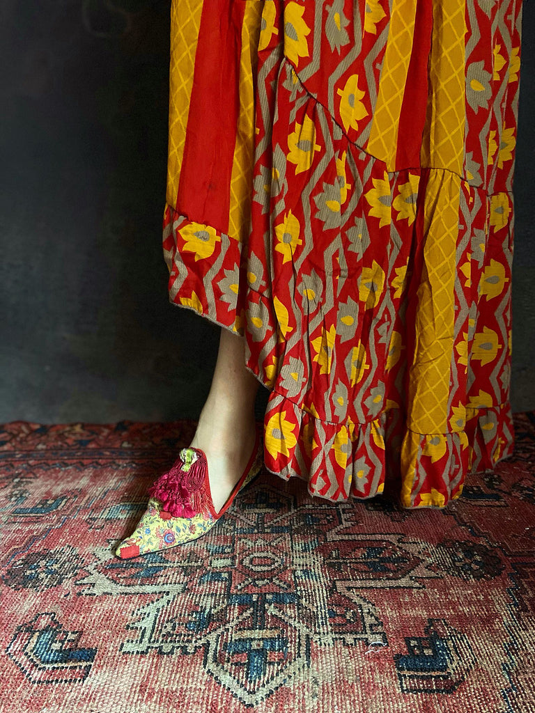Pavilion Parade handmade shoes created from antique textiles, available from Joanne Fleming Design. 17th century Florentine silk tassels and block printed French Indienne cotton create bohemian flat shoes in shades of yellow, red and blue