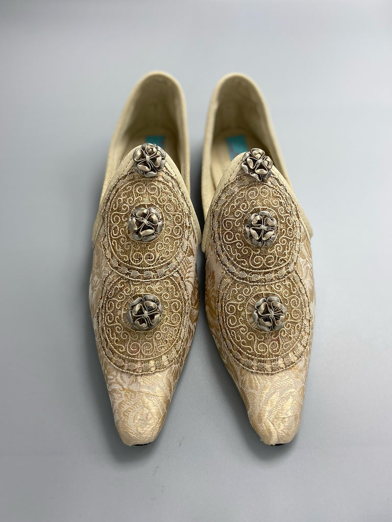 Cream and rose gold silk damask pointed toe shoes  with linen and gold metallic filigree lacework medallions. Finished with little vintage silk passementerie rosettes. Bohemian costume shoes created from antique textiles by Pavilion Parade.