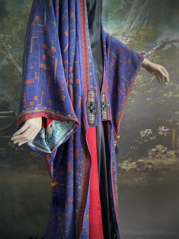Egyptian Revival 1920s inspired full length robe created from vintage and antique textiles. Lapiz lazuli blue and scarlet silk crepe. Lined in block printed silk with design of ancient Egyptian figures, pyramids, chariots. Bohemian style from Pavilion Parade.