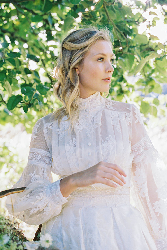 Ivory French lace and silk organza fitted romantic blouse. Antique lace elements at high fitted collar and cuffs. Full bishop sleeves and pleated bodice front. A flight of fancy from the Pavilion Parade studio. Photo by Mariel Hannah.