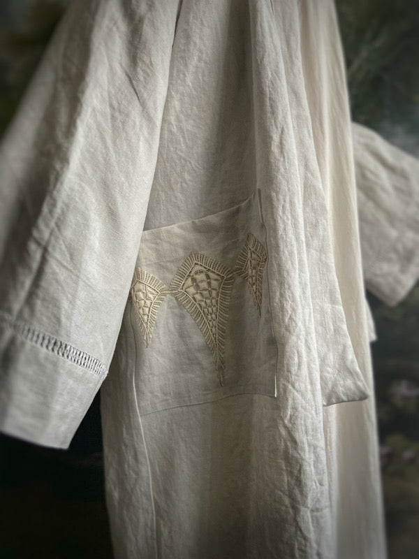 Full length kimono inspired robe with large patch pockets and wide sleeves. Created from an antique heavy French linen trousseau sheet with heirloom embroidery and drawn thread work. All French seamed with hand finished hems and collar. Bohemian styles sustainably created from antique and vintage textiles by the Pavilion Parade studio.
