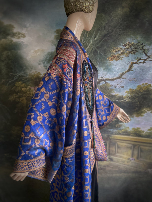 Egyptian Revival 1920s inspired full length robe created from vintage and antique textiles. Lapiz lazuli blue and metallic bronze-gold silk brocade. Lined in block printed silk with design of ancient Egyptian figures, pyramids, chariots. Bohemian style from Pavilion Parade.