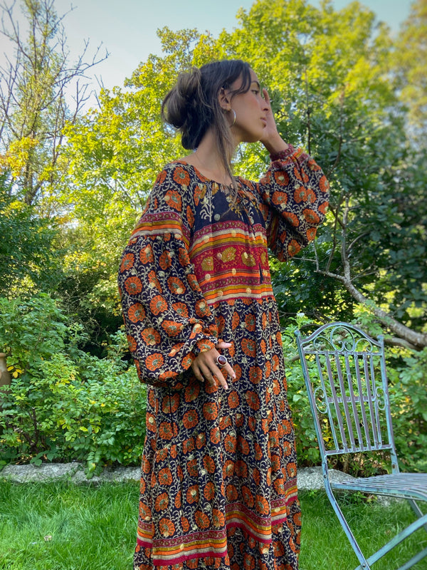 Black, burnt orange, and chilli red silk georgette maxi dress with tassel drawstring neckline, long full sleeves and side pockets. Bohemian style sustainably created from vintage and antique textiles by the Pavilion Parade studio.