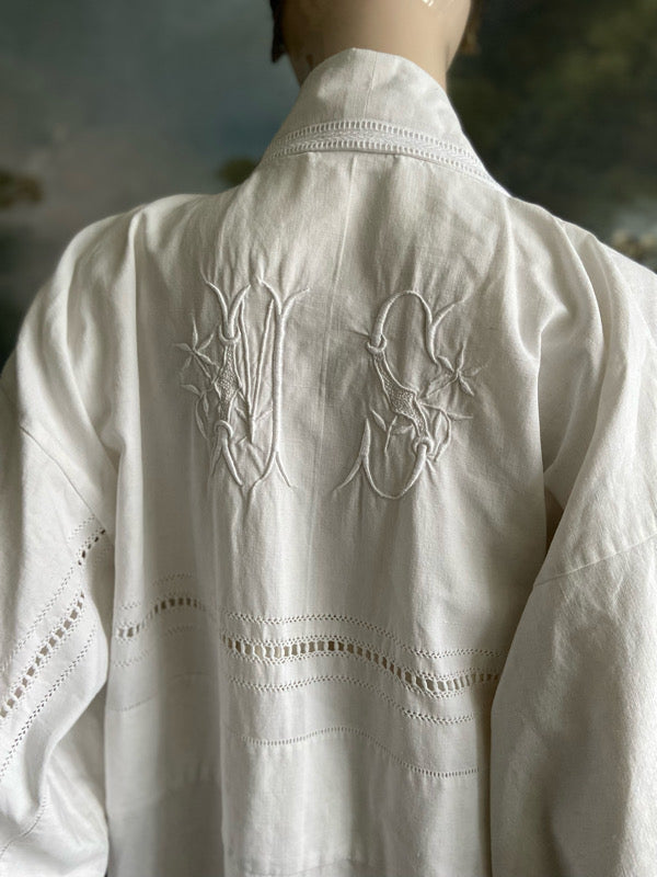 Full length kimono inspired robe with large patch pockets and wide sleeves. Created from an antique heavy French linen trousseau sheet with heirloom embroidery and drawn thread work. All French seamed with hand finished hems and collar. Bohemian styles sustainably created from antique and vintage textiles by the Pavilion Parade studio.
