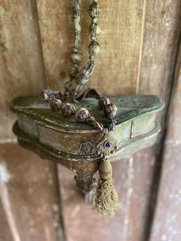 1920s style long silk sautoir necklace with antique tassel embellishment. Bohemian style from vintage textiles by Pavilion Parade. 