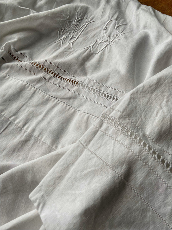 Full length kimono inspired robe with large patch pockets and wide sleeves. Created from an antique heavy French linen trousseau sheet with heirloom embroidery and drawn thread work. All French seamed with hand finished hems and collar. Bohemian styles sustainably created from antique and vintage textiles by the Pavilion Parade studio.
