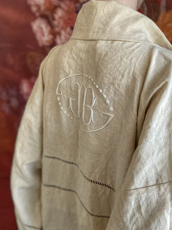 Full length kimono inspired robe with large patch pockets and wide sleeves. Created from an antique heavy French linen trousseau sheet with heirloom embroidery and drawn thread work. All French seamed with hand finished hems and collar. Bohemian styles sustainably created from antique and vintage textiles by the Pavilion Parade studio.