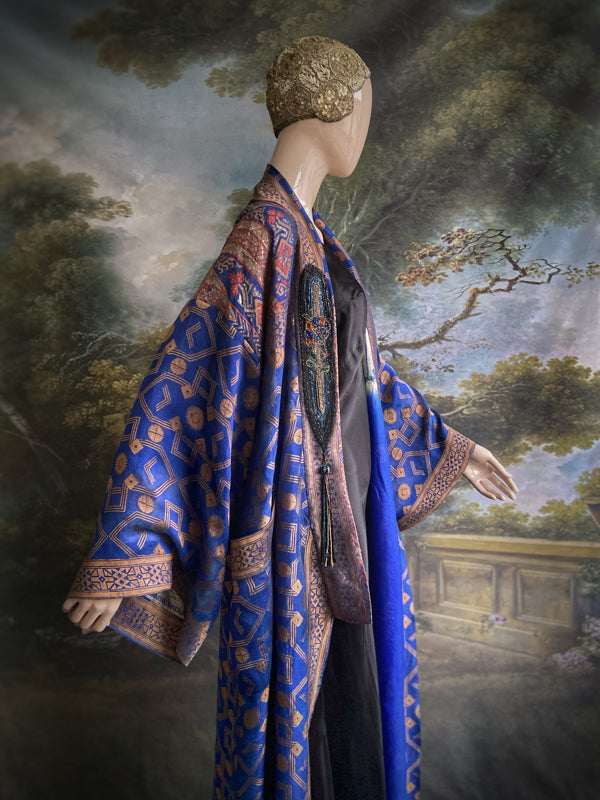 Egyptian Revival 1920s inspired full length robe created from vintage and antique textiles. Lapiz lazuli blue and metallic bronze-gold silk brocade. Lined in block printed silk with design of ancient Egyptian figures, pyramids, chariots. Bohemian style from Pavilion Parade.
