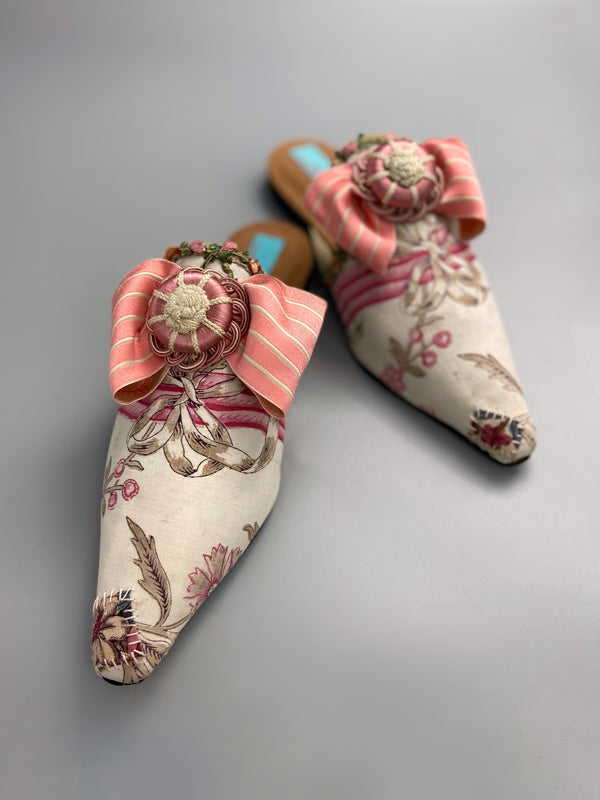 Marie Antoinette inspired shoes created from antique early 1800s rose pink and ivory block printed French cotton toile and embellished with pink silk passementerie rosettes. Bohemian style from the Pavilion Parade studio.