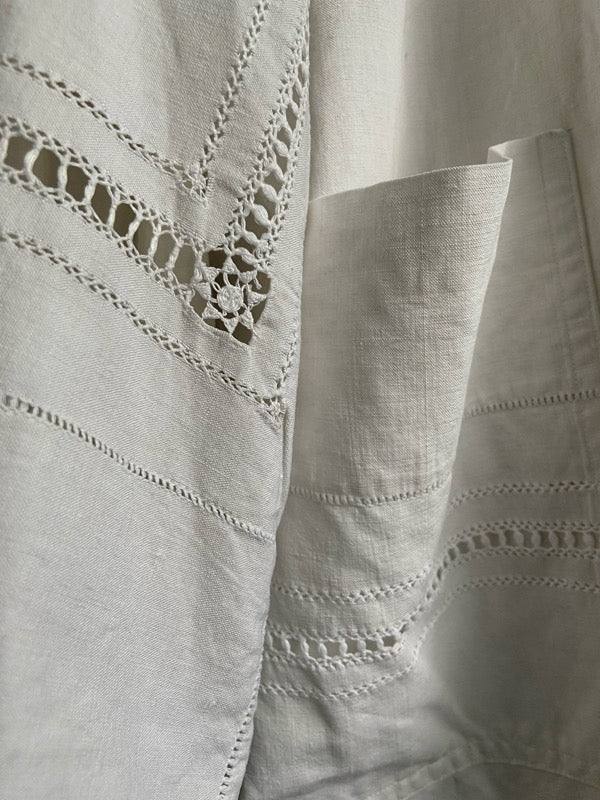 Full length kimono inspired robe with large patch pockets and wide sleeves. Created from an antique heavy French linen trousseau sheet with heirloom embroidery and drawn thread work. All French seamed with hand finished hems and collar. Bohemian styles sustainably created from antique and vintage textiles by the Pavilion Parade studio.
