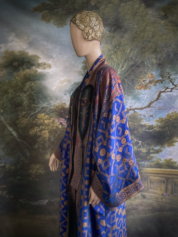 Egyptian Revival 1920s inspired full length robe created from vintage and antique textiles. Lapiz lazuli blue and metallic bronze-gold silk brocade. Lined in block printed silk with design of ancient Egyptian figures, pyramids, chariots. Bohemian style from Pavilion Parade.