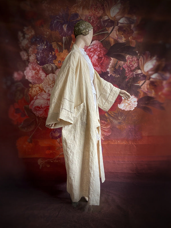 Full length kimono inspired robe with large patch pockets and wide sleeves. Created from an antique heavy French linen trousseau sheet with heirloom embroidery and drawn thread work. All French seamed with hand finished hems and collar. Bohemian styles sustainably created from antique and vintage textiles by the Pavilion Parade studio.