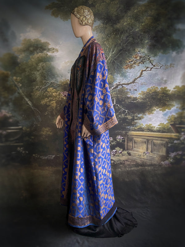 Egyptian Revival 1920s inspired full length robe created from vintage and antique textiles. Lapiz lazuli blue and metallic bronze-gold silk brocade. Lined in block printed silk with design of ancient Egyptian figures, pyramids, chariots. Bohemian style from Pavilion Parade.