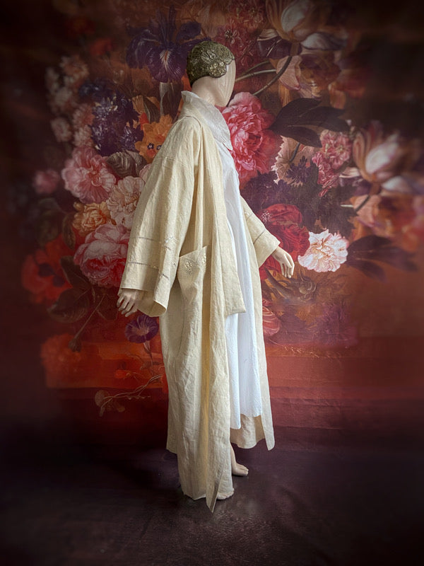 Full length kimono inspired robe with large patch pockets and wide sleeves. Created from an antique heavy French linen trousseau sheet with heirloom embroidery and drawn thread work. All French seamed with hand finished hems and collar. Bohemian styles sustainably created from antique and vintage textiles by the Pavilion Parade studio.
