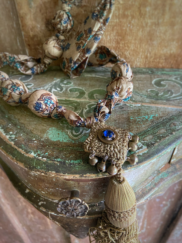 1920s style long silk sautoir necklace with antique tassel embellishment. Bohemian style from vintage textiles by Pavilion Parade. 