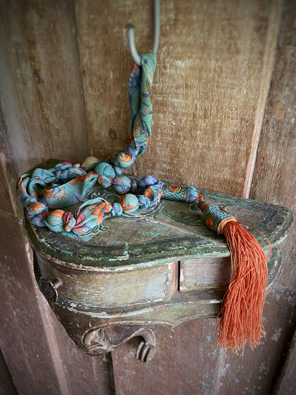 1920s style long silk sautoir necklace with antique tassel embellishment. Bohemian style from vintage textiles by Pavilion Parade. 