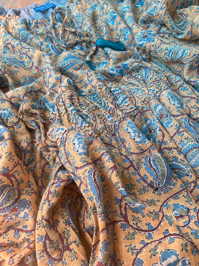 Faded ochre yellow and slate blue-grey cotton muslin block printed dress with long full sleeves and adjustable drawstring neckline. Bohemian styles sustainably created from antique and vintage textiles by the Pavilion Parade studio. 
