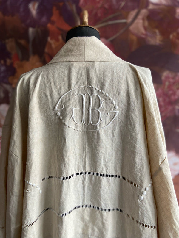 Full length kimono inspired robe with large patch pockets and wide sleeves. Created from an antique heavy French linen trousseau sheet with heirloom embroidery and drawn thread work. All French seamed with hand finished hems and collar. Bohemian styles sustainably created from antique and vintage textiles by the Pavilion Parade studio.
