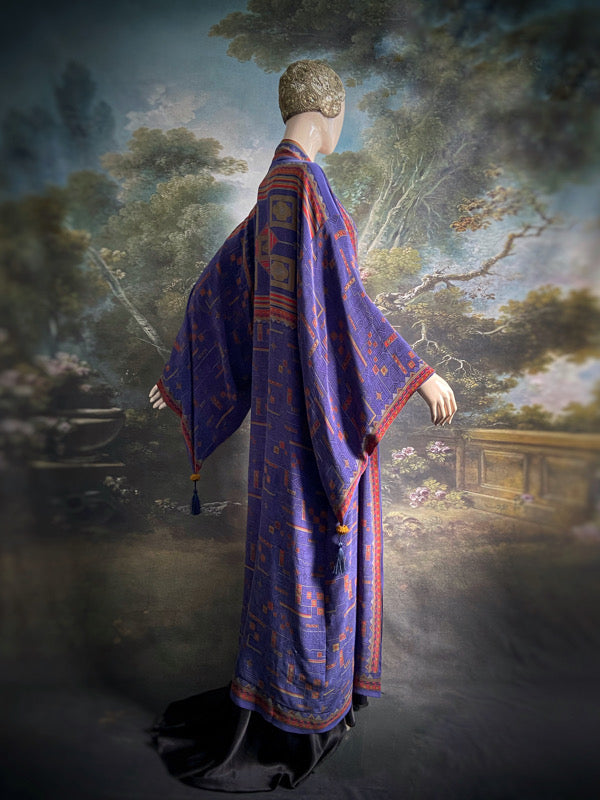 Egyptian Revival 1920s inspired full length robe created from vintage and antique textiles. Lapiz lazuli blue and scarlet silk crepe. Lined in block printed silk with design of ancient Egyptian figures, pyramids, chariots. Bohemian style from Pavilion Parade.