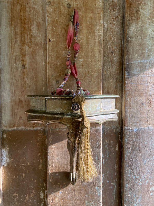 1920s style long silk sautoir necklace with antique tassel embellishment. Bohemian style from vintage textiles by Pavilion Parade. 