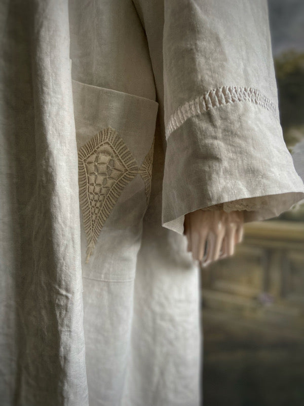 Full length kimono inspired robe with large patch pockets and wide sleeves. Created from an antique heavy French linen trousseau sheet with heirloom embroidery and drawn thread work. All French seamed with hand finished hems and collar. Bohemian styles sustainably created from antique and vintage textiles by the Pavilion Parade studio.
