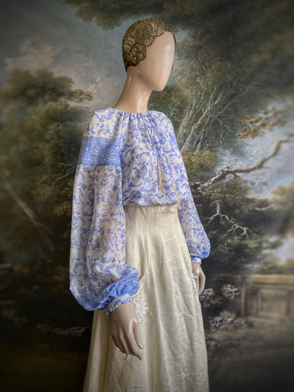China blue and white cotton muslin block printed blouse with long full sleeves and adjustable drawstring neckline. Bohemian styles sustainably created from antique and vintage textiles by the Pavilion Parade studio. 