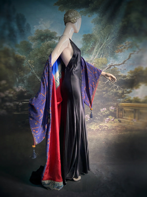 Egyptian Revival 1920s inspired full length robe created from vintage and antique textiles. Lapiz lazuli blue and scarlet silk crepe. Lined in block printed silk with design of ancient Egyptian figures, pyramids, chariots. Bohemian style from Pavilion Parade.
