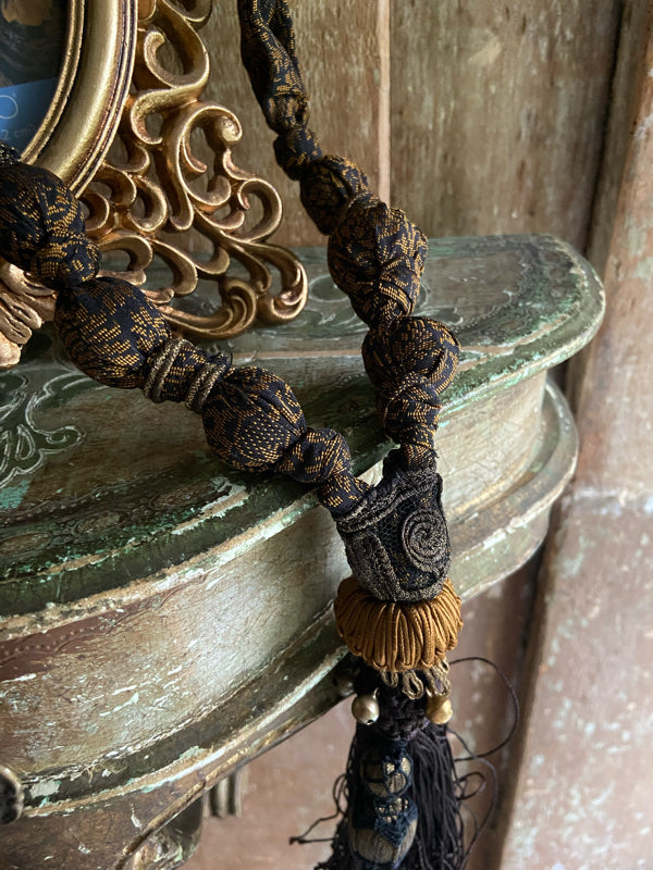 1920s style long silk sautoir necklace with antique tassel embellishment. Bohemian style from vintage textiles by Pavilion Parade. 