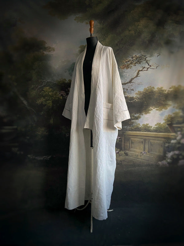 Full length kimono inspired robe with large patch pockets and wide sleeves. Created from an antique heavy French linen monogrammed trousseau sheet with hand embroidered butterflies and drawn thread work. All French seamed with hand finished hems and collar. Bohemian styles sustainably created from antique and vintage textiles by the Pavilion Parade studio.