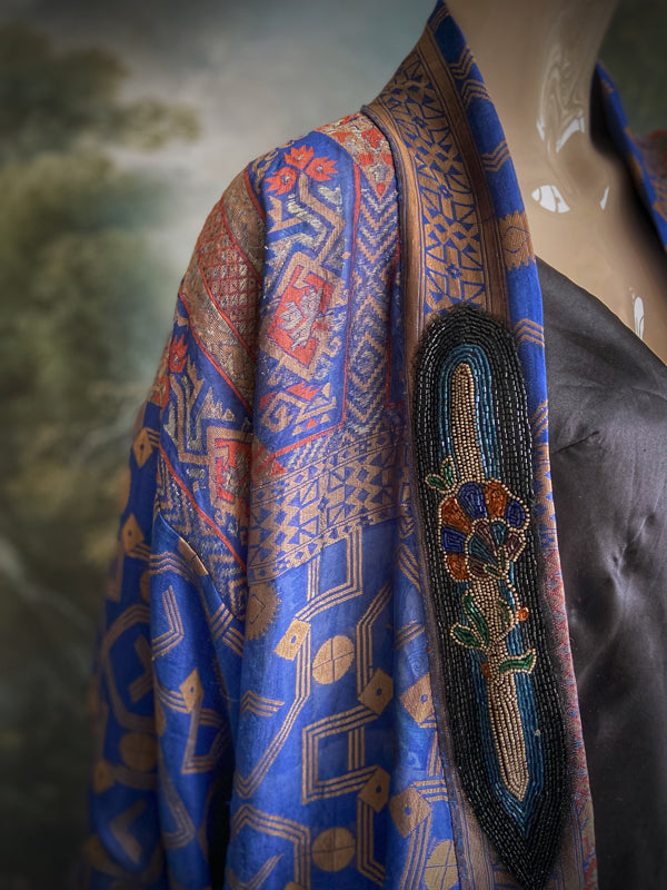 Egyptian Revival 1920s inspired full length robe created from vintage and antique textiles. Lapiz lazuli blue and metallic bronze-gold silk brocade. Lined in block printed silk with design of ancient Egyptian figures, pyramids, chariots. Bohemian style from Pavilion Parade.