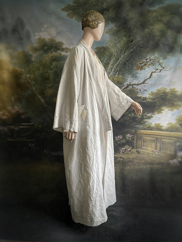 Full length kimono inspired robe with large patch pockets and wide sleeves. Created from an antique heavy French linen trousseau sheet with heirloom embroidery and drawn thread work. All French seamed with hand finished hems and collar. Bohemian styles sustainably created from antique and vintage textiles by the Pavilion Parade studio.
