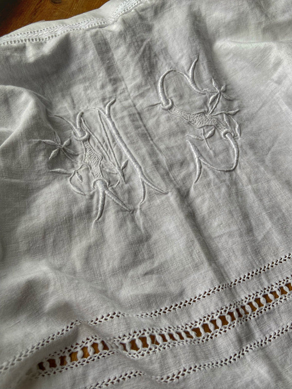 Full length kimono inspired robe with large patch pockets and wide sleeves. Created from an antique heavy French linen trousseau sheet with heirloom embroidery and drawn thread work. All French seamed with hand finished hems and collar. Bohemian styles sustainably created from antique and vintage textiles by the Pavilion Parade studio.
