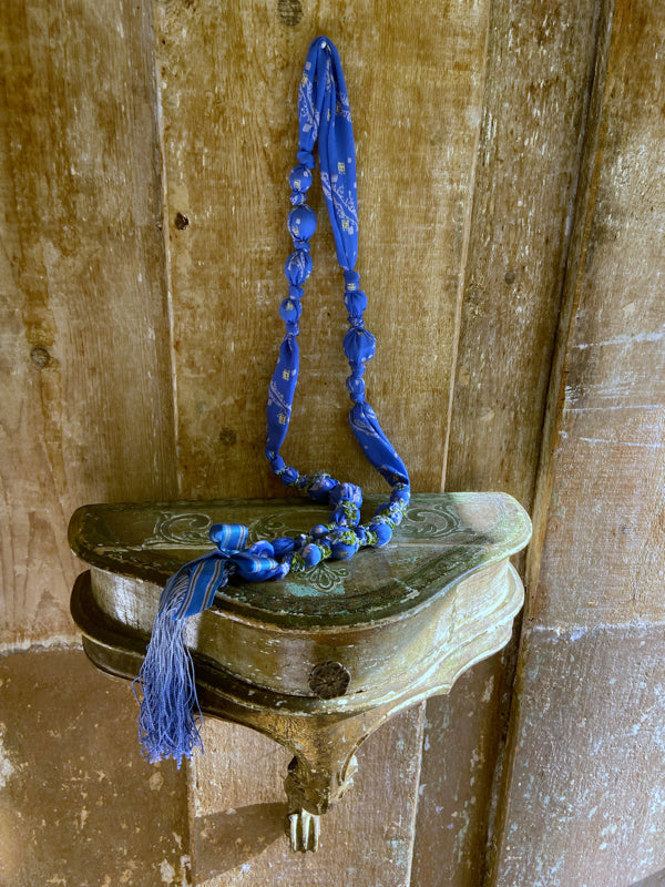 1920s style long silk sautoir necklace with antique tassel embellishment. Bohemian style from vintage textiles by Pavilion Parade. 