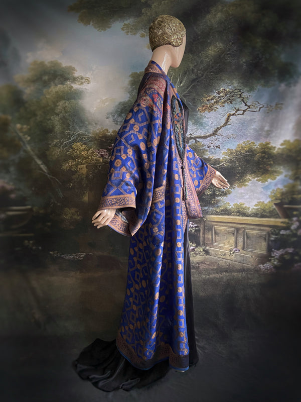 Egyptian Revival 1920s inspired full length robe created from vintage and antique textiles. Lapiz lazuli blue and metallic bronze-gold silk brocade. Lined in block printed silk with design of ancient Egyptian figures, pyramids, chariots. Bohemian style from Pavilion Parade.
