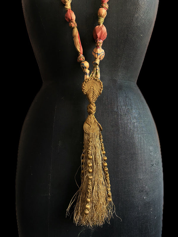 1920s style long silk sautoir necklace with antique tassel embellishment. Bohemian style from vintage textiles by Pavilion Parade. 