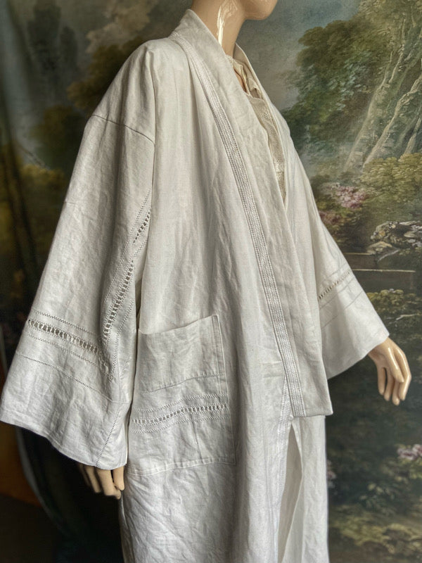Full length kimono inspired robe with large patch pockets and wide sleeves. Created from an antique heavy French linen trousseau sheet with heirloom embroidery and drawn thread work. All French seamed with hand finished hems and collar. Bohemian styles sustainably created from antique and vintage textiles by the Pavilion Parade studio.
