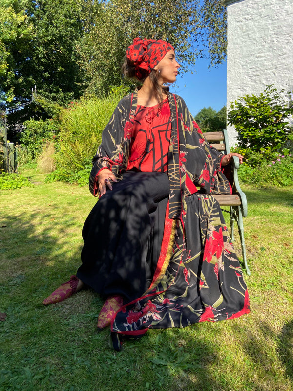 Full length 1920s inspired kimono robe with large patch pockets. Newly created from a scarlet and black 1930s style splashy floral vintage silk crepe. Fully lined in silk with French seams throughout. Bohemian styles sustainably created from antique and vintage textiles by the Pavilion Parade studio.