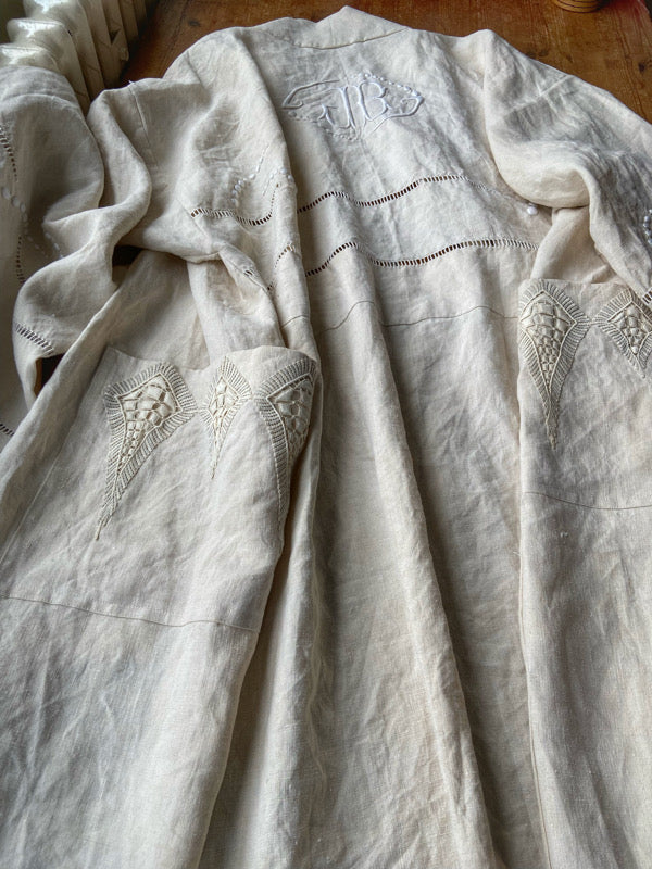 Full length kimono inspired robe with large patch pockets and wide sleeves. Created from an antique heavy French linen trousseau sheet with heirloom embroidery and drawn thread work. All French seamed with hand finished hems and collar. Bohemian styles sustainably created from antique and vintage textiles by the Pavilion Parade studio.