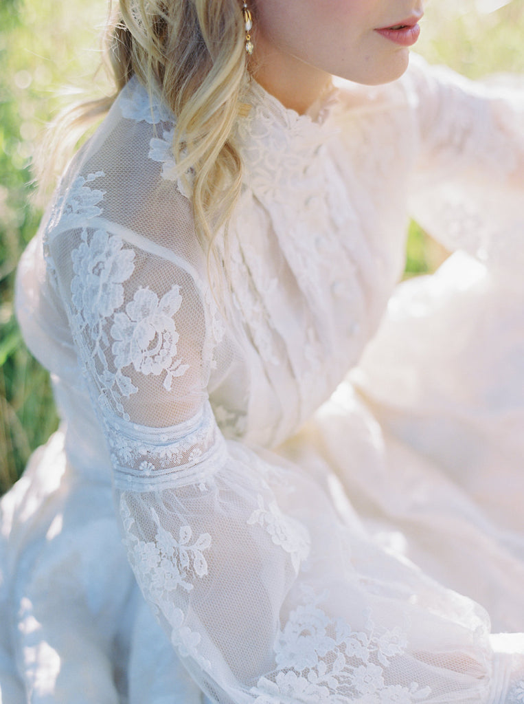 Ivory French lace and silk organza fitted romantic blouse. Antique lace elements at high fitted collar and cuffs. Full bishop sleeves and pleated bodice front. A flight of fancy from the Pavilion Parade studio. Photo by Mariel Hannah.