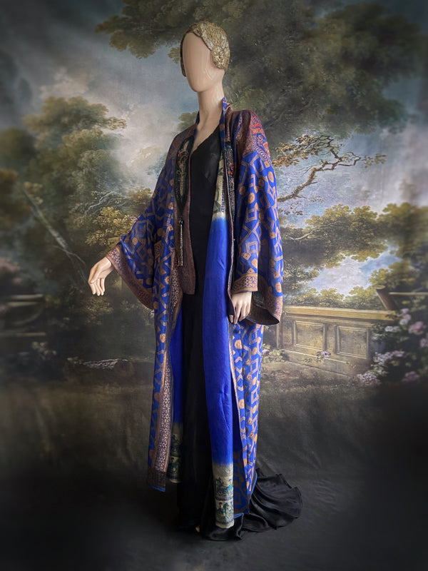 Egyptian Revival 1920s inspired full length robe created from vintage and antique textiles. Lapiz lazuli blue and metallic bronze-gold silk brocade. Lined in block printed silk with design of ancient Egyptian figures, pyramids, chariots. Bohemian style from Pavilion Parade.