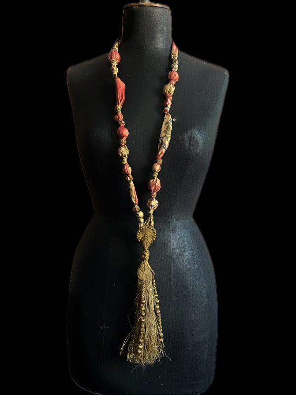 1920s style long silk sautoir necklace with antique tassel embellishment. Bohemian style from vintage textiles by Pavilion Parade. 