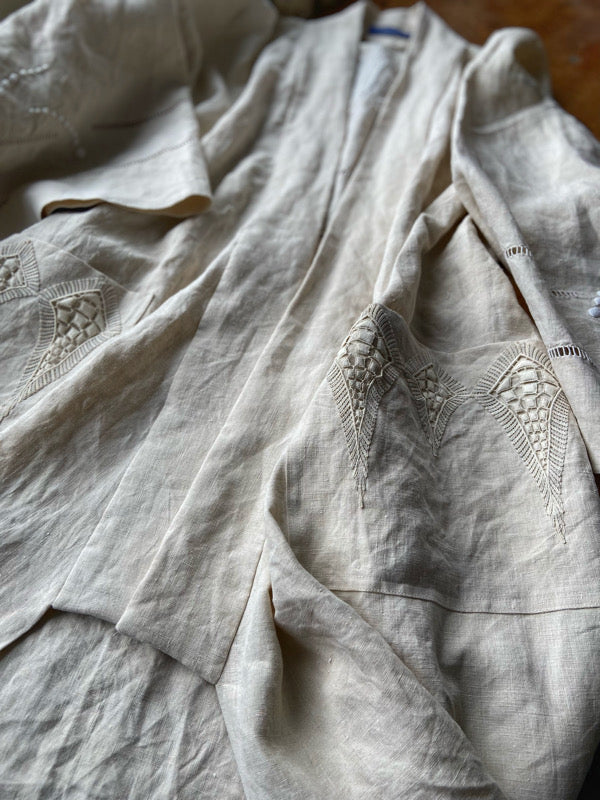 Full length kimono inspired robe with large patch pockets and wide sleeves. Created from an antique heavy French linen trousseau sheet with heirloom embroidery and drawn thread work. All French seamed with hand finished hems and collar. Bohemian styles sustainably created from antique and vintage textiles by the Pavilion Parade studio.