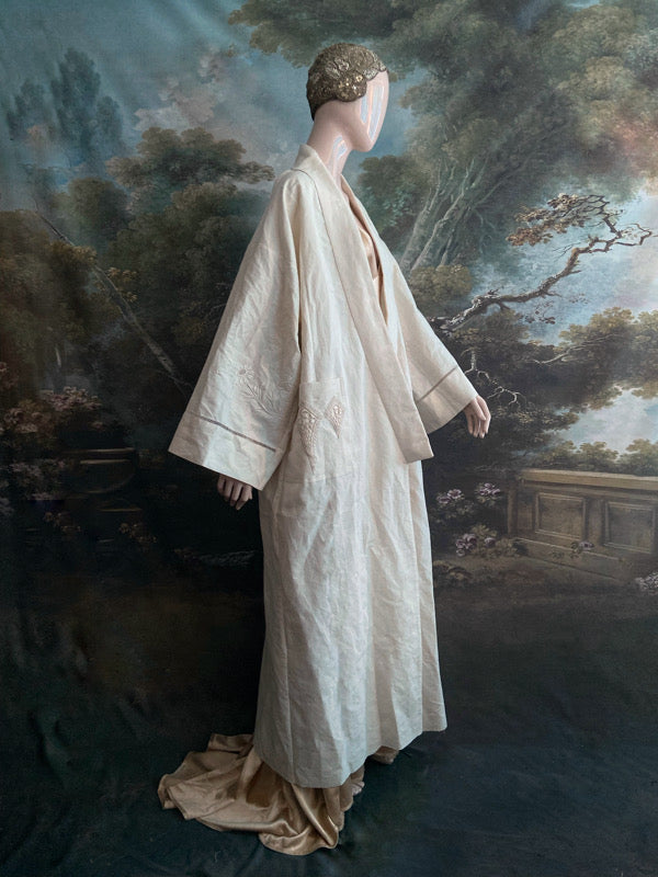 Full length kimono inspired robe with large patch pockets and wide sleeves. Created from an antique heavy French linen trousseau sheet with heirloom embroidery and drawn thread work. All French seamed with hand finished hems and collar. Bohemian styles sustainably created from antique and vintage textiles by the Pavilion Parade studio.
