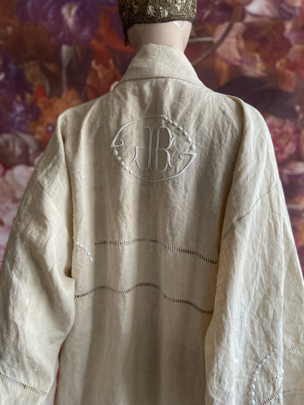 Full length kimono inspired robe with large patch pockets and wide sleeves. Created from an antique heavy French linen trousseau sheet with heirloom embroidery and drawn thread work. All French seamed with hand finished hems and collar. Bohemian styles sustainably created from antique and vintage textiles by the Pavilion Parade studio.