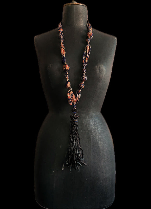 1920s style long silk sautoir necklace with antique tassel embellishment. Bohemian style from vintage textiles by Pavilion Parade. 