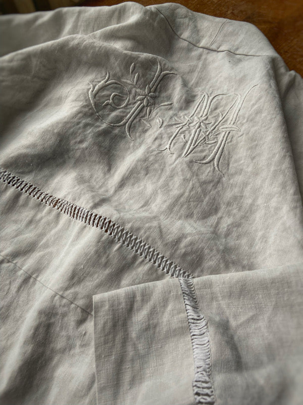 Full length kimono inspired robe with large patch pockets and wide sleeves. Created from an antique heavy French linen trousseau sheet with heirloom embroidery and drawn thread work. All French seamed with hand finished hems and collar. Bohemian styles sustainably created from antique and vintage textiles by the Pavilion Parade studio.
