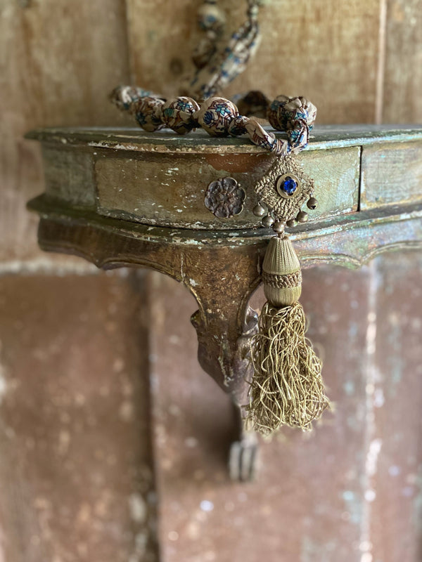 1920s style long silk sautoir necklace with antique tassel embellishment. Bohemian style from vintage textiles by Pavilion Parade. 