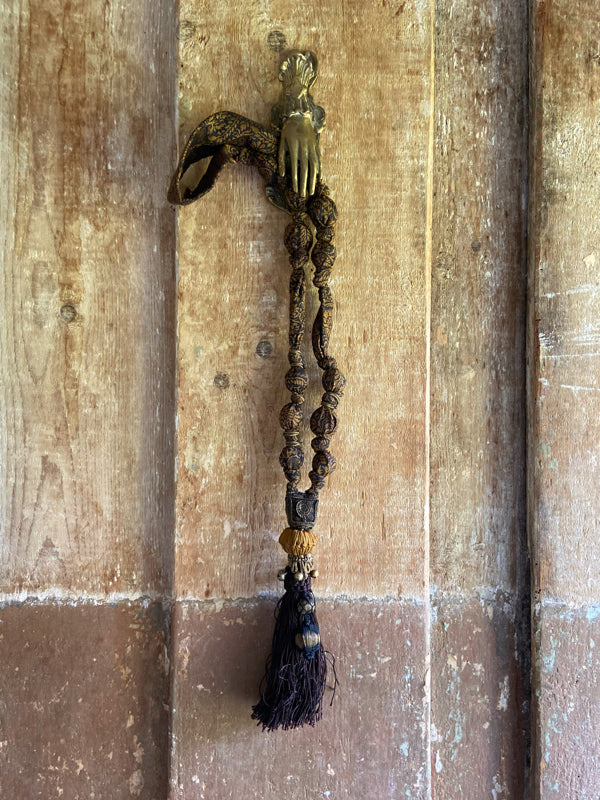 1920s style long silk sautoir necklace with antique tassel embellishment. Bohemian style from vintage textiles by Pavilion Parade. 