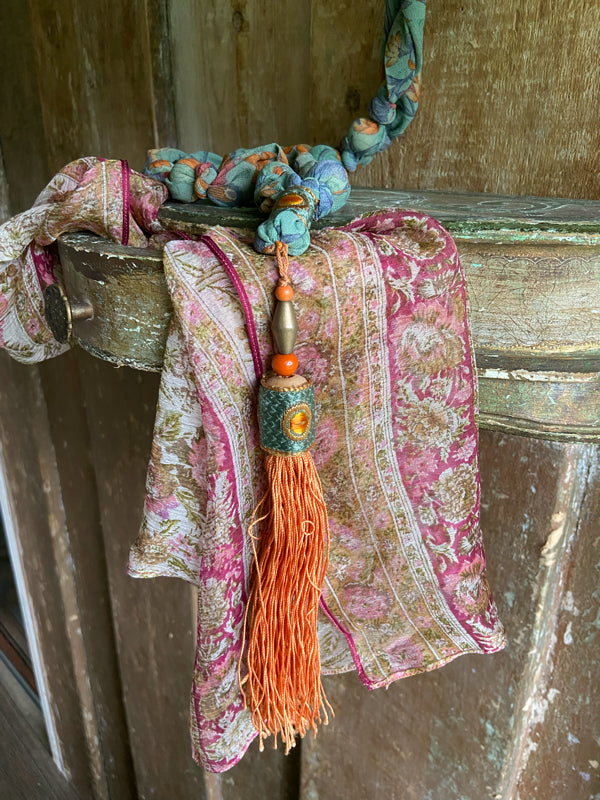 1920s style long silk sautoir necklace with antique tassel embellishment. Bohemian style from vintage textiles by Pavilion Parade. 
