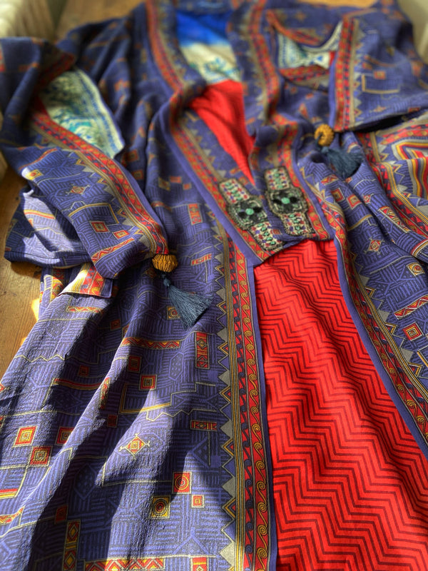 Egyptian Revival 1920s inspired full length robe created from vintage and antique textiles. Lapiz lazuli blue and scarlet silk crepe. Lined in block printed silk with design of ancient Egyptian figures, pyramids, chariots. Bohemian style from Pavilion Parade.